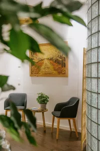 a room with chairs and a painting on the wall